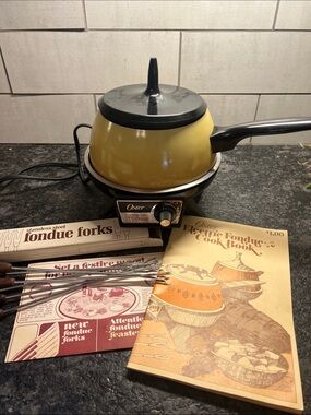 Vintage Oster MCM Harvest Gold Electric Fondue Set with Black Lid and Handle.